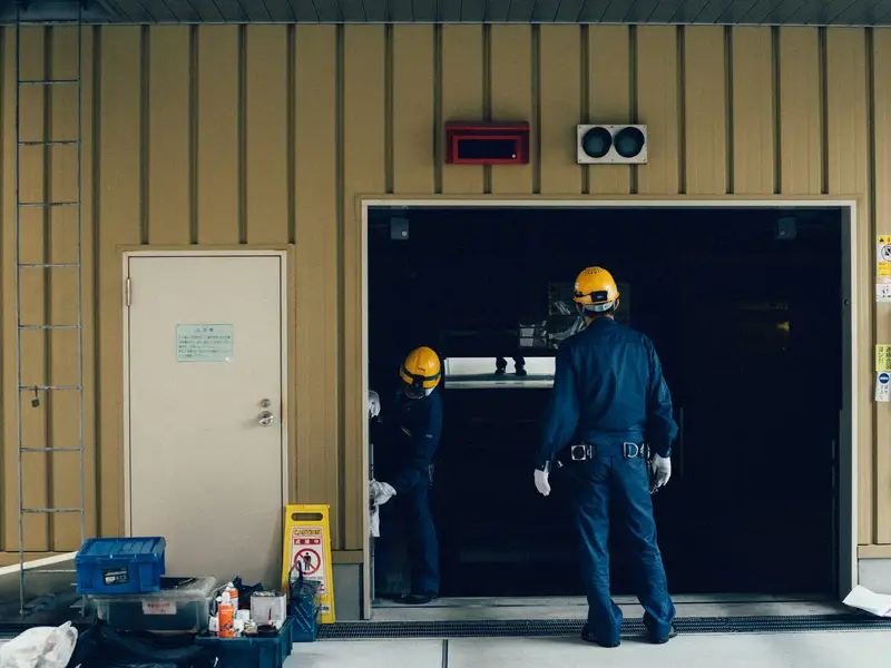 Proline technicians servicing a commercial overhead door in Calgary